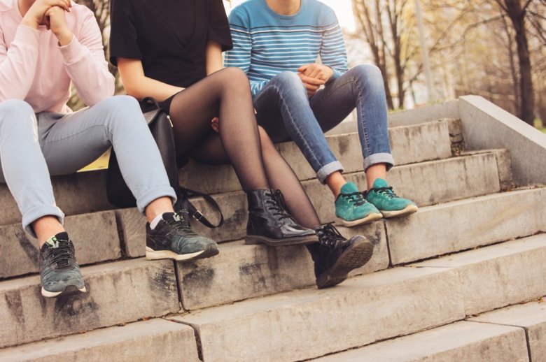 Teenagers sitting in stairs