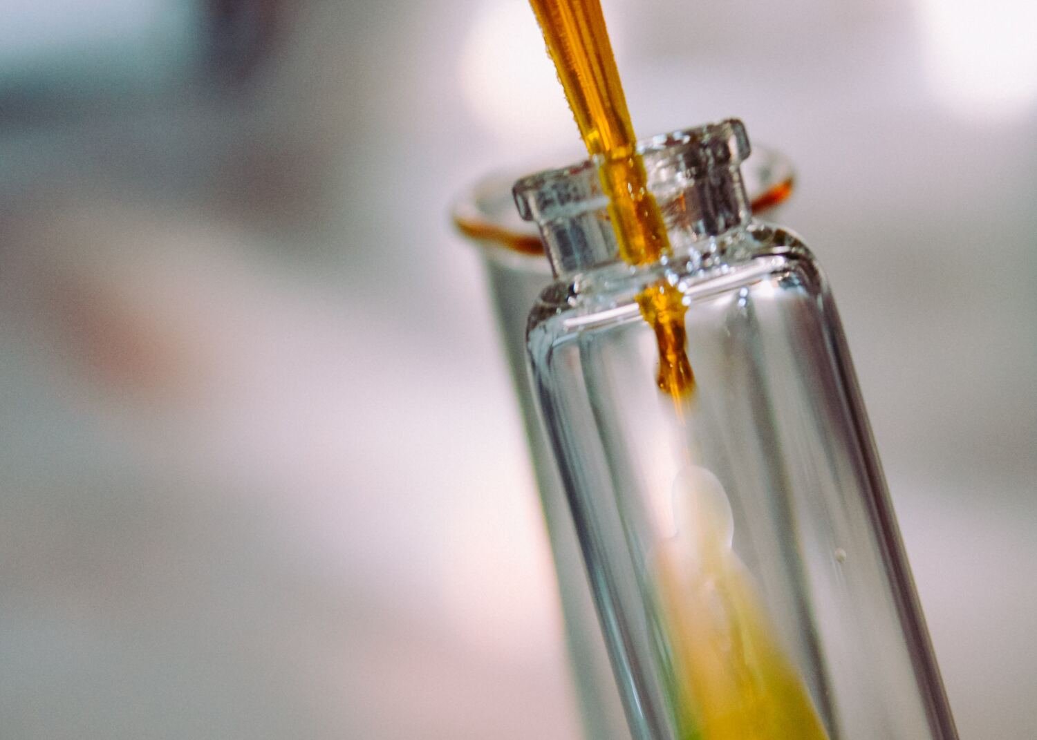 Clear glass bottle with yellow liquid