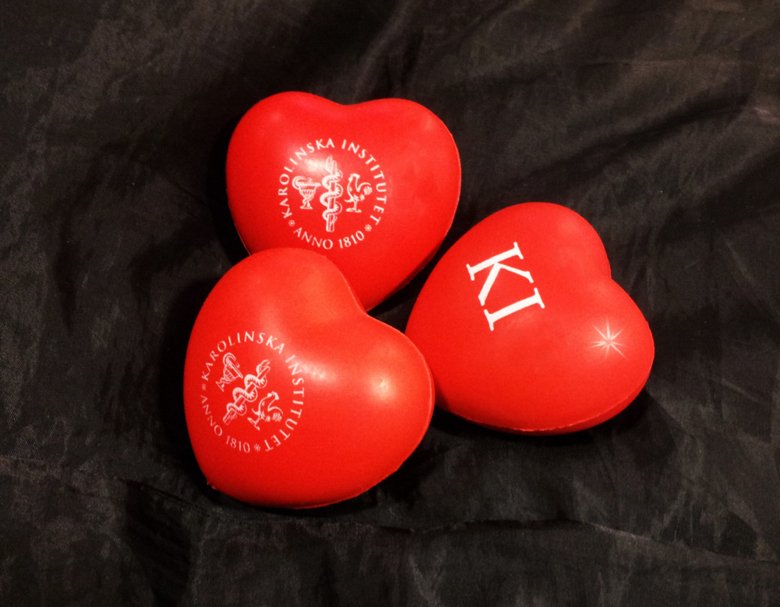 Three red hearts with the logotype of Karolinska Institutet