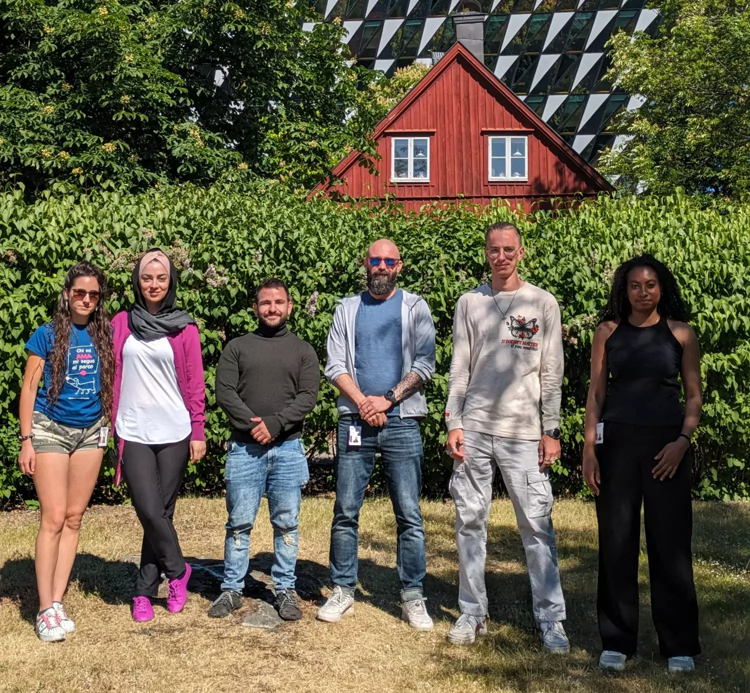 Group picture of lab members outside in front of the Aula, KI Campus Solna.