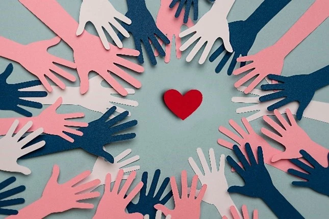 Hands reaching towards a heart