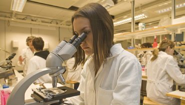 Woman looking in a microscope