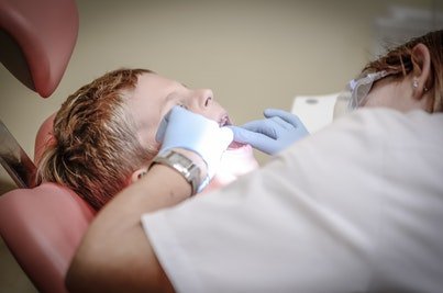 Child being examined by a dentist.