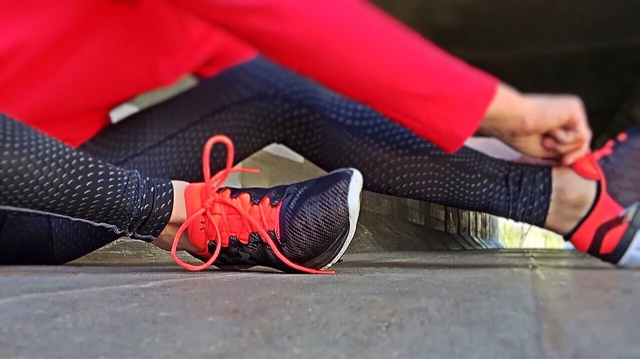 Person tying shoelaces on running shoes