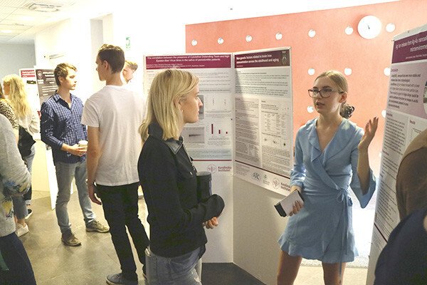 Student listens to speakers at an exhibition outside the lecture hall