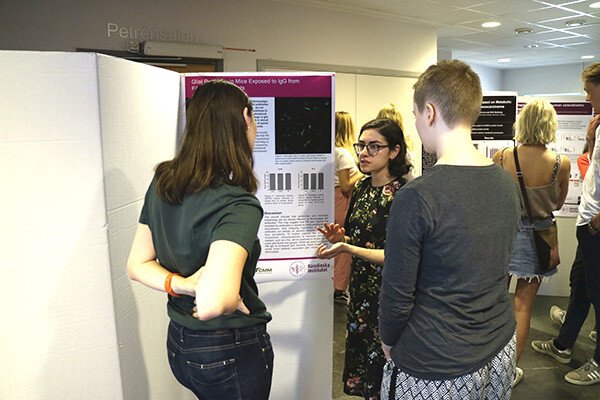 Student listens to speakers at an exhibition outside the lecture hall