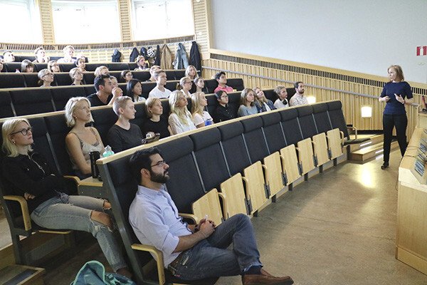 Students sit in the lecture hall and listen