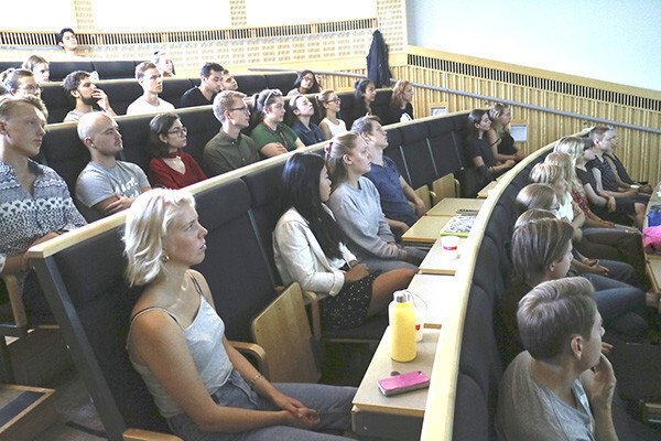 Students in the lecture hall listening