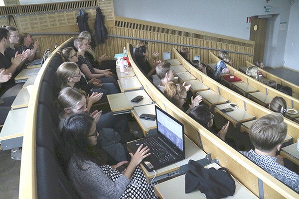 Students in the lecture hall listening