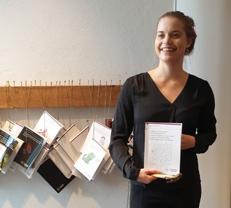 Anne Leppänen holding her thesis in front of her before nailing it at LIME.