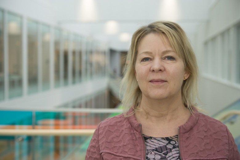 Close-up photo of a woman inside a building