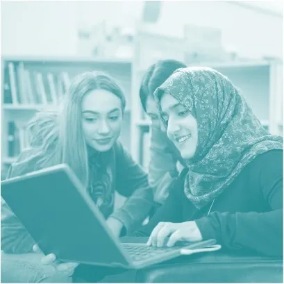 Three people looking at a laptop.