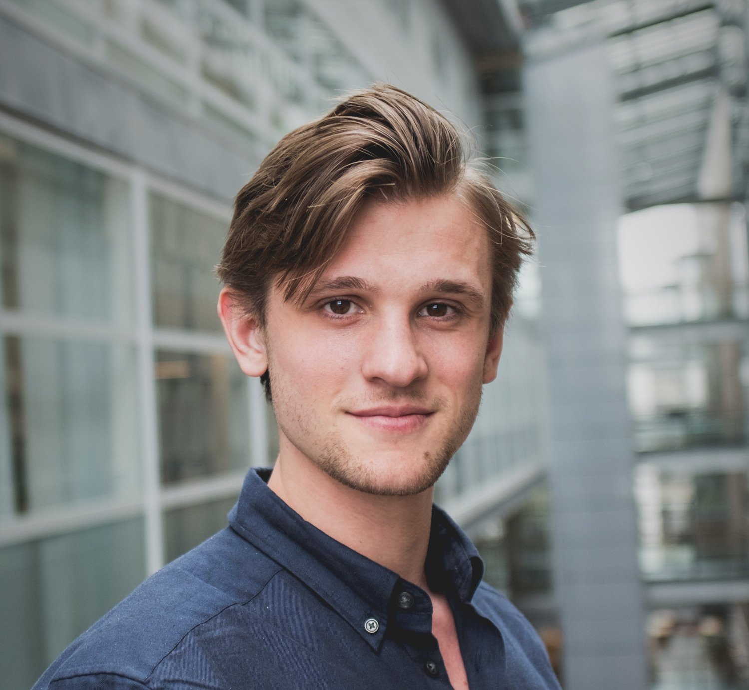Portrait of a man in a dark shirt.