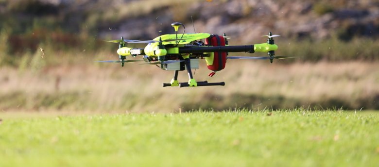 close upp image on a bright yellow drone with an attached defibrillator.