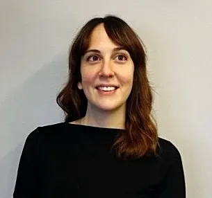Picture of a smiling woman with dark wavy hair