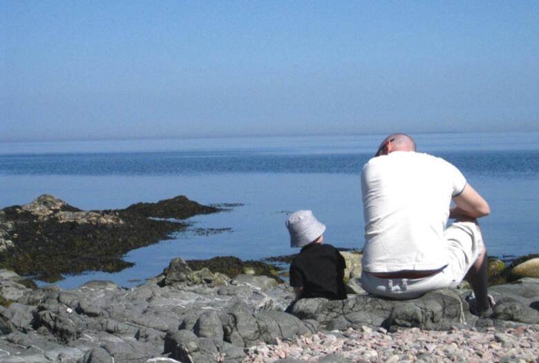 Förälder och barn vid havet.