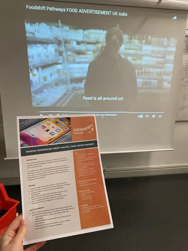 Image of a film in the background and a leaflet in the foreground.