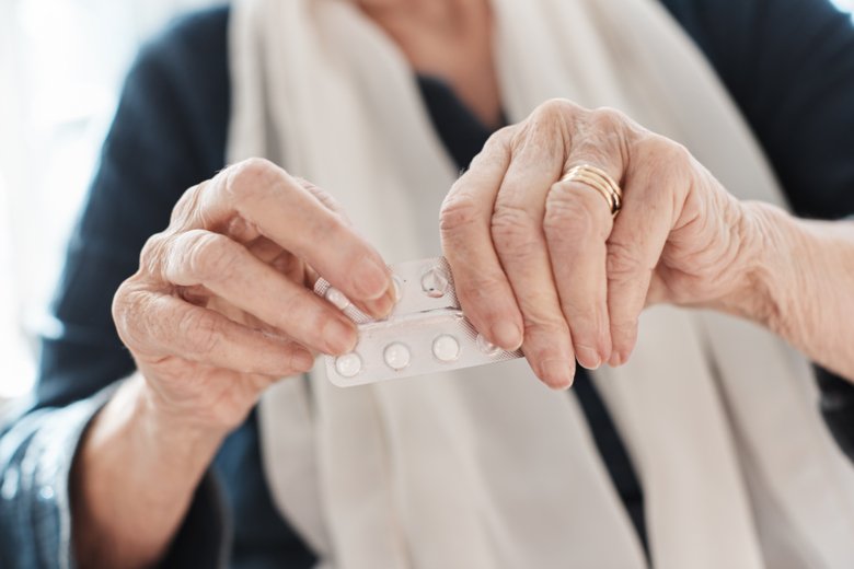 Äldre kvinna tar medicin