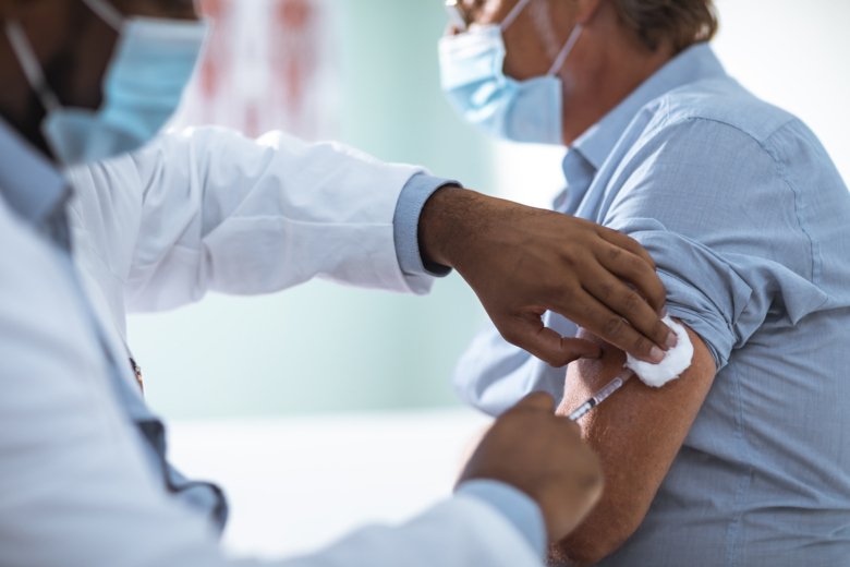 Person with face mask getting vaccine