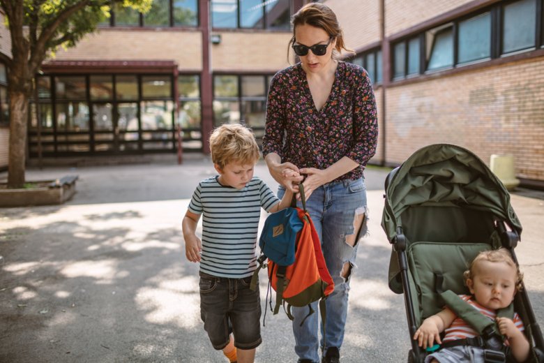 A mum with kids at a schoolyard