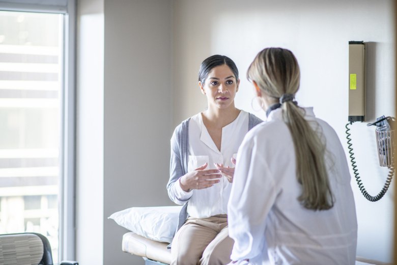 a female doctor with a female patient