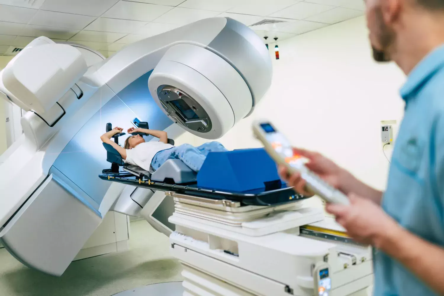 Picture of woman lying on a bunk and going to x-ray.