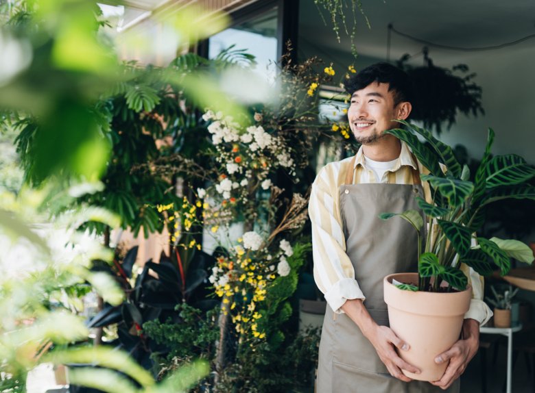 Happy man in flower shop.