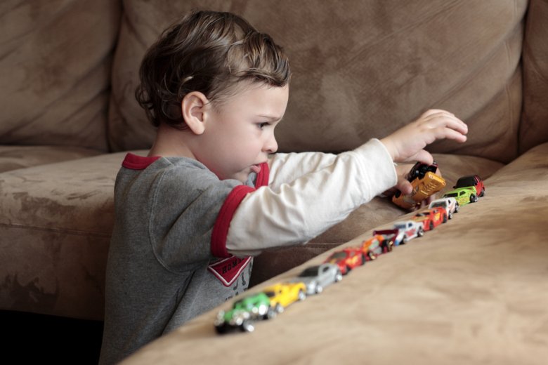 Child playing with cars