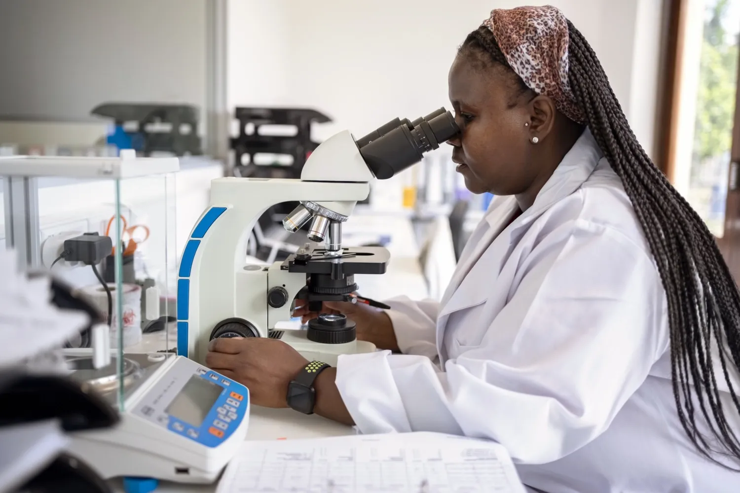 Woman looking through microscope