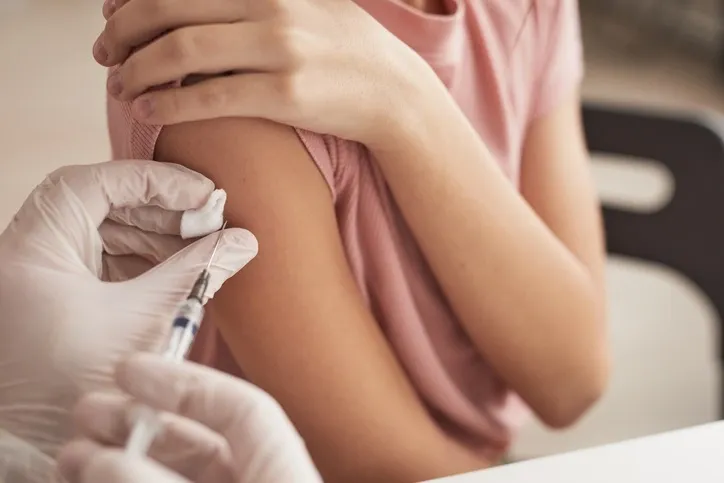 Girl being vaccinated