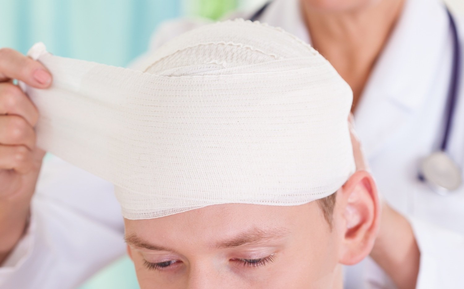 Man with bandage around his head.