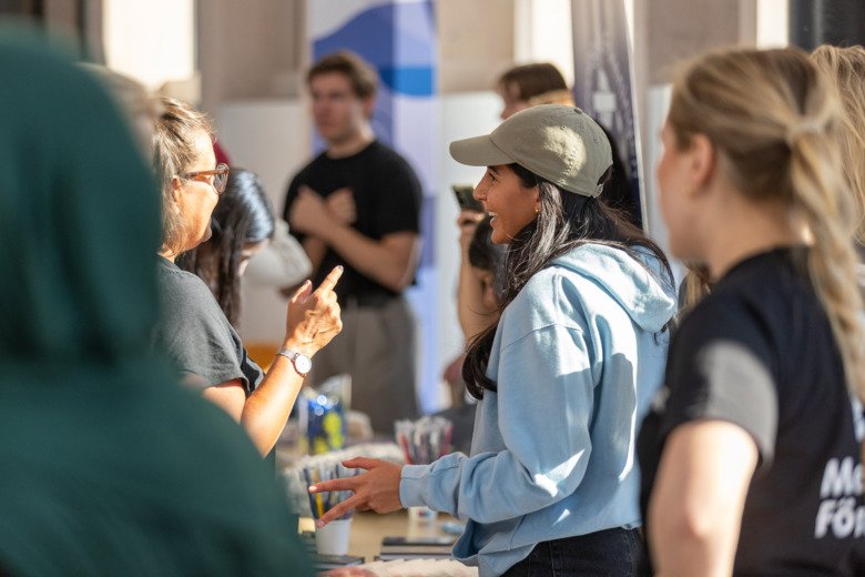 Student and staff talking during the study fair