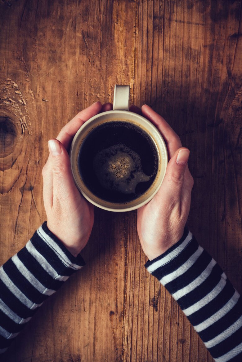 Hans holding a cup of coffee