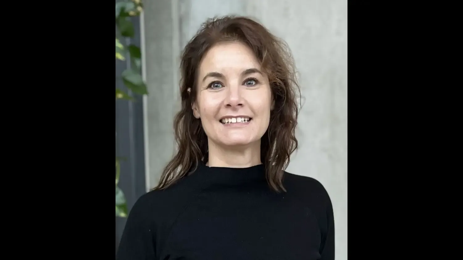 Profile photo of a brown haired woman in a black top