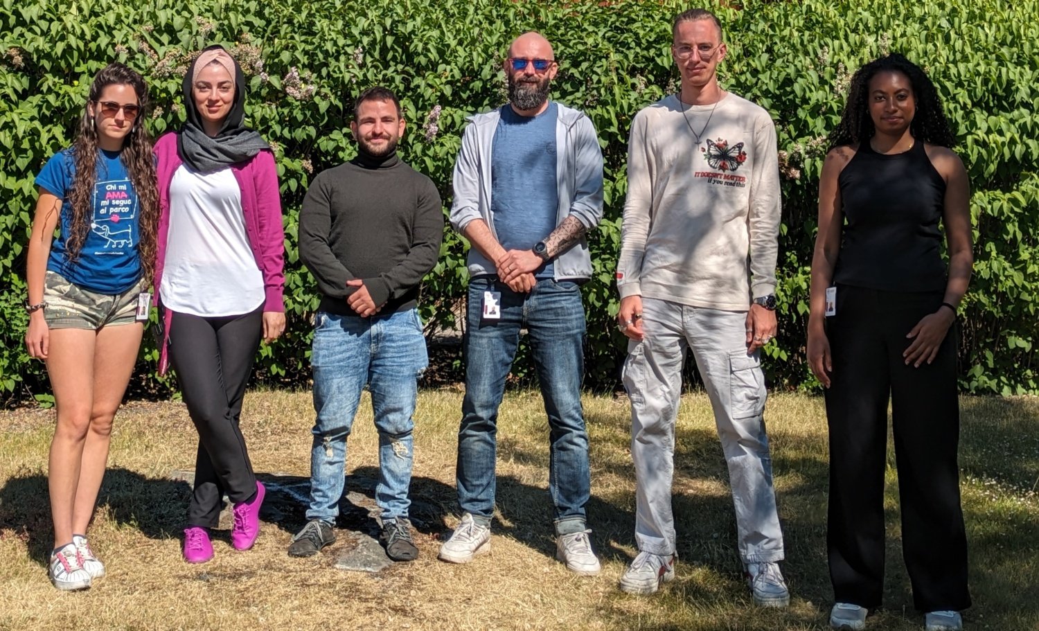 Group picture of lab members outside in front of the Aula, KI Campus Solna.