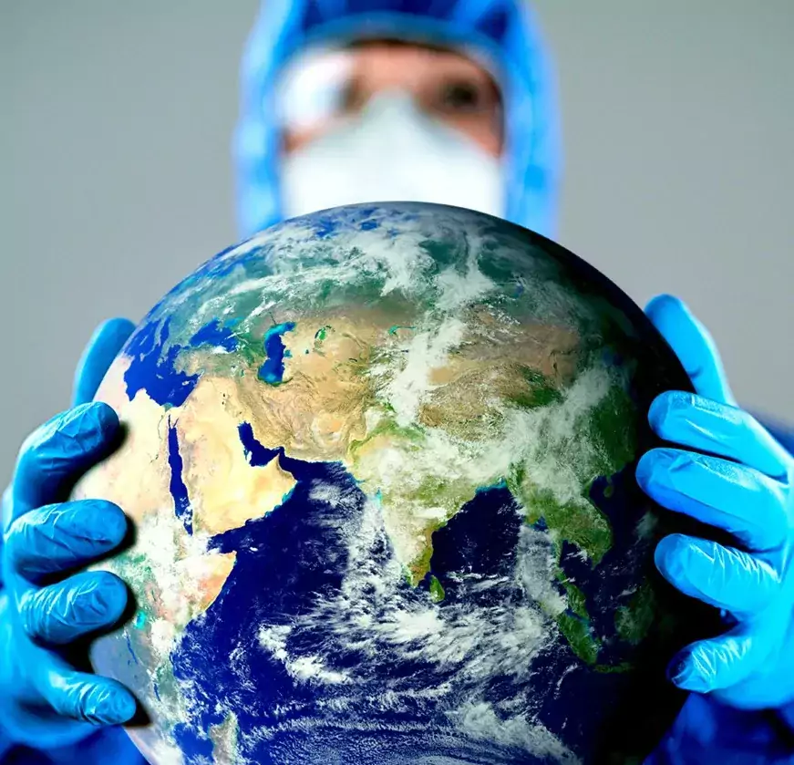 Man in PPE holding a globe