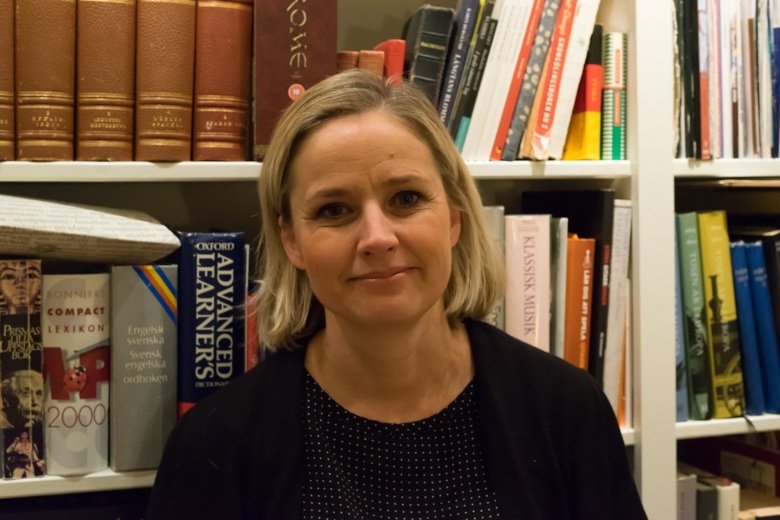 Photo of a woman in front of a bookshelf