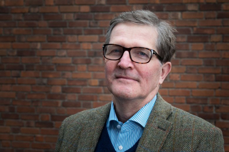 Picture of Mats Persson wearing glasses in front of a brick wall.