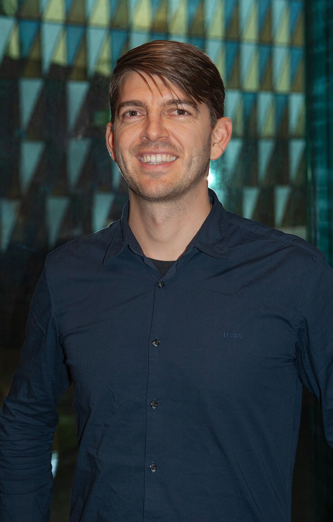 A man smiling for the portrait.