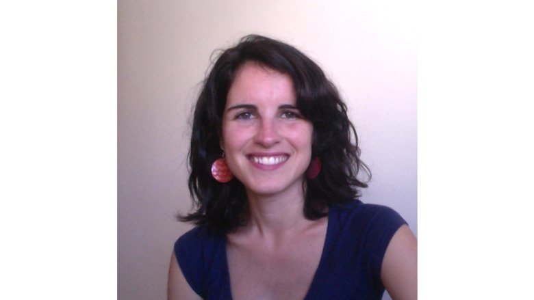 Profile photo of Nieves Amat Camacho. A woman with dark hair and a blue top