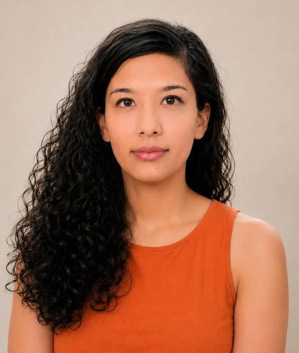 A profile photo of a woman with dark hair and an orange top