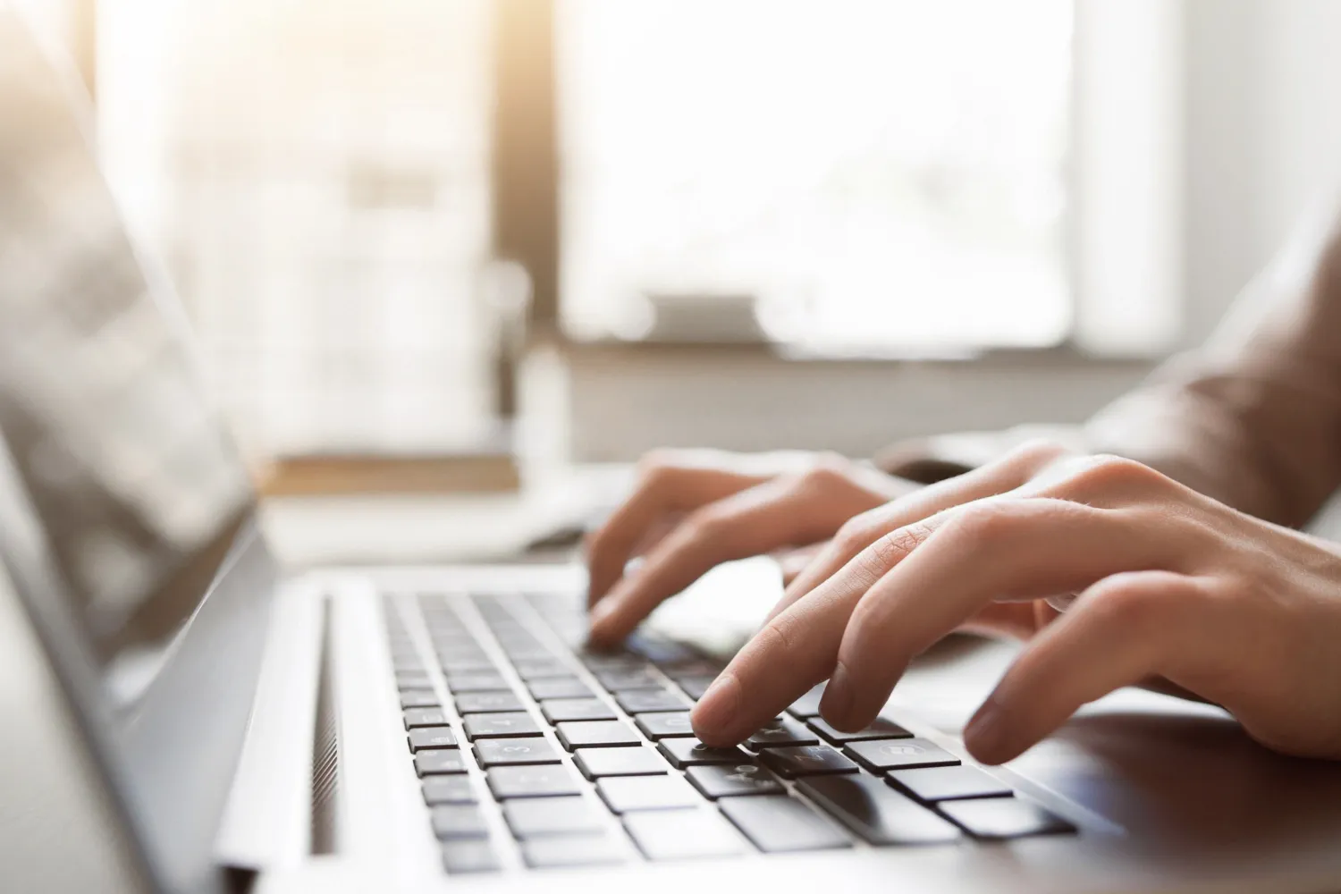 A person writing on a computer