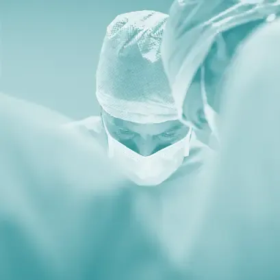 Surgeon in operation wearing face mask and hair net