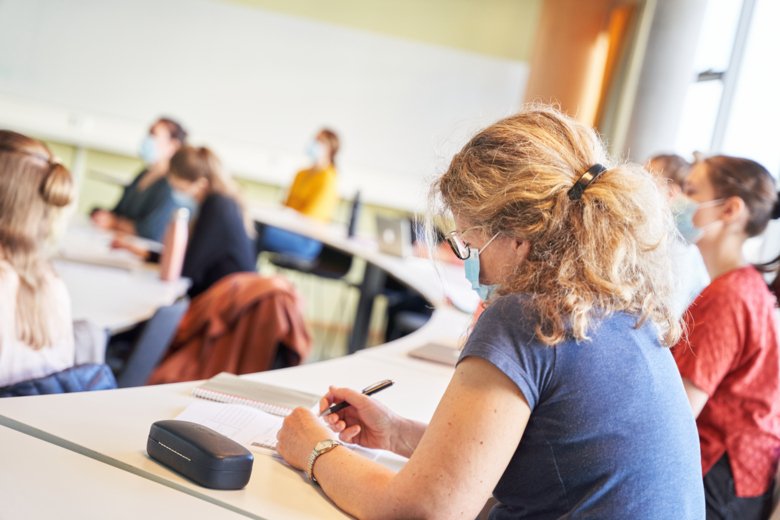 Lecture hall with students wearing face masks.