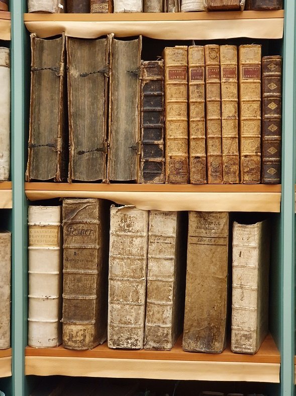 Part of bookshelf with books from the Hagstromer Library.