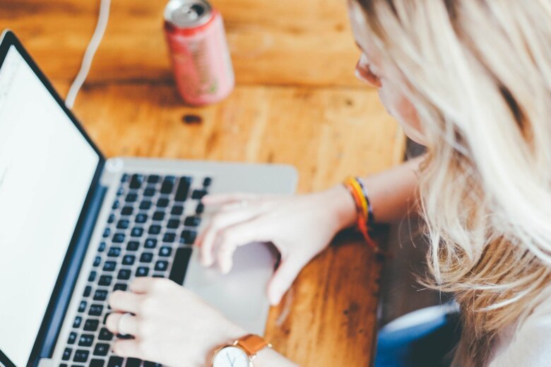 Image of blond woman in front of a computer screen.