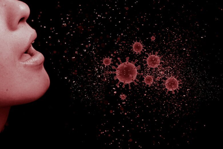 Genre image of coronavirus near a human nose and open mouth.