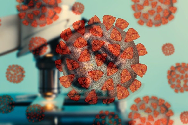 The image shows illustrated and colourful coronavirus with a microscope in the background.