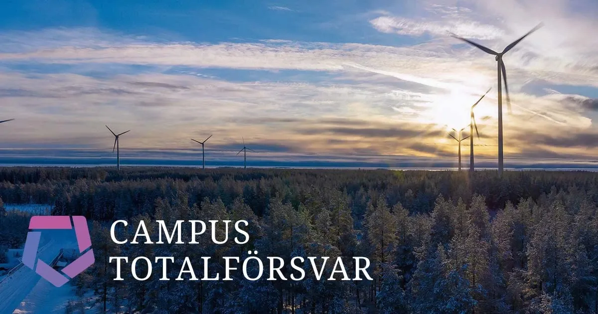 View over a wintery forest with wind turbines