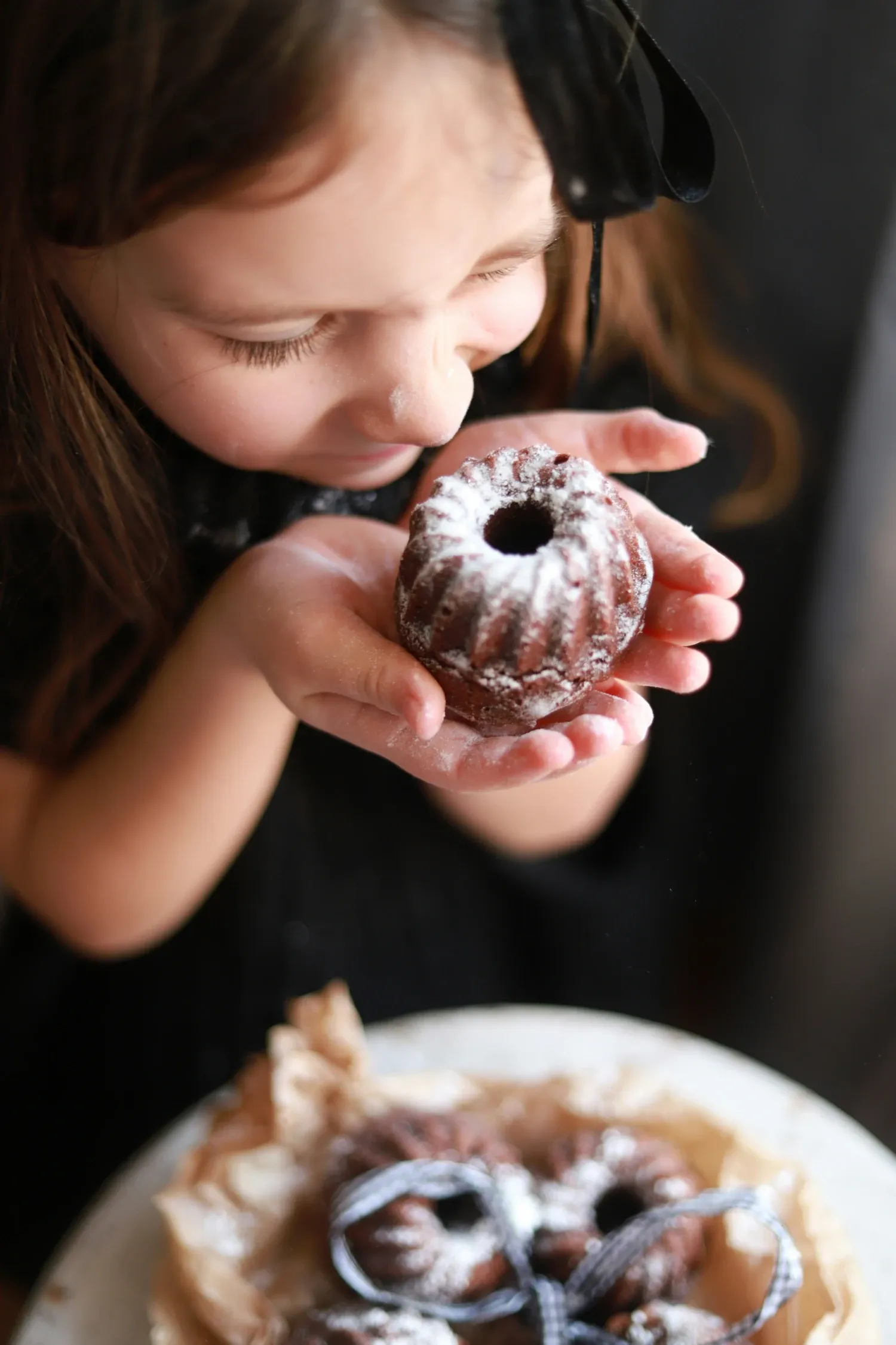 Child smelling a cake